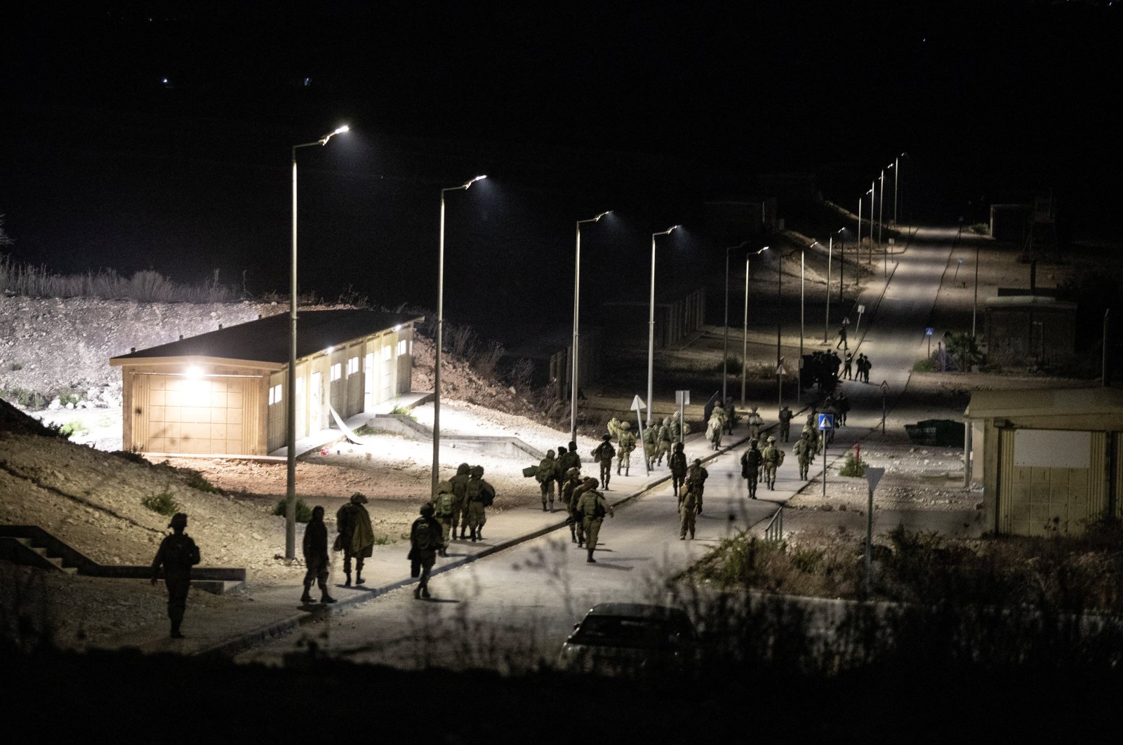 Israeli soldiers walk near the scene of a Hezbollah drone attack that killed at least four troops, in Binyamina, Israel, Oct. 13, 2024. (Reuters Photo)