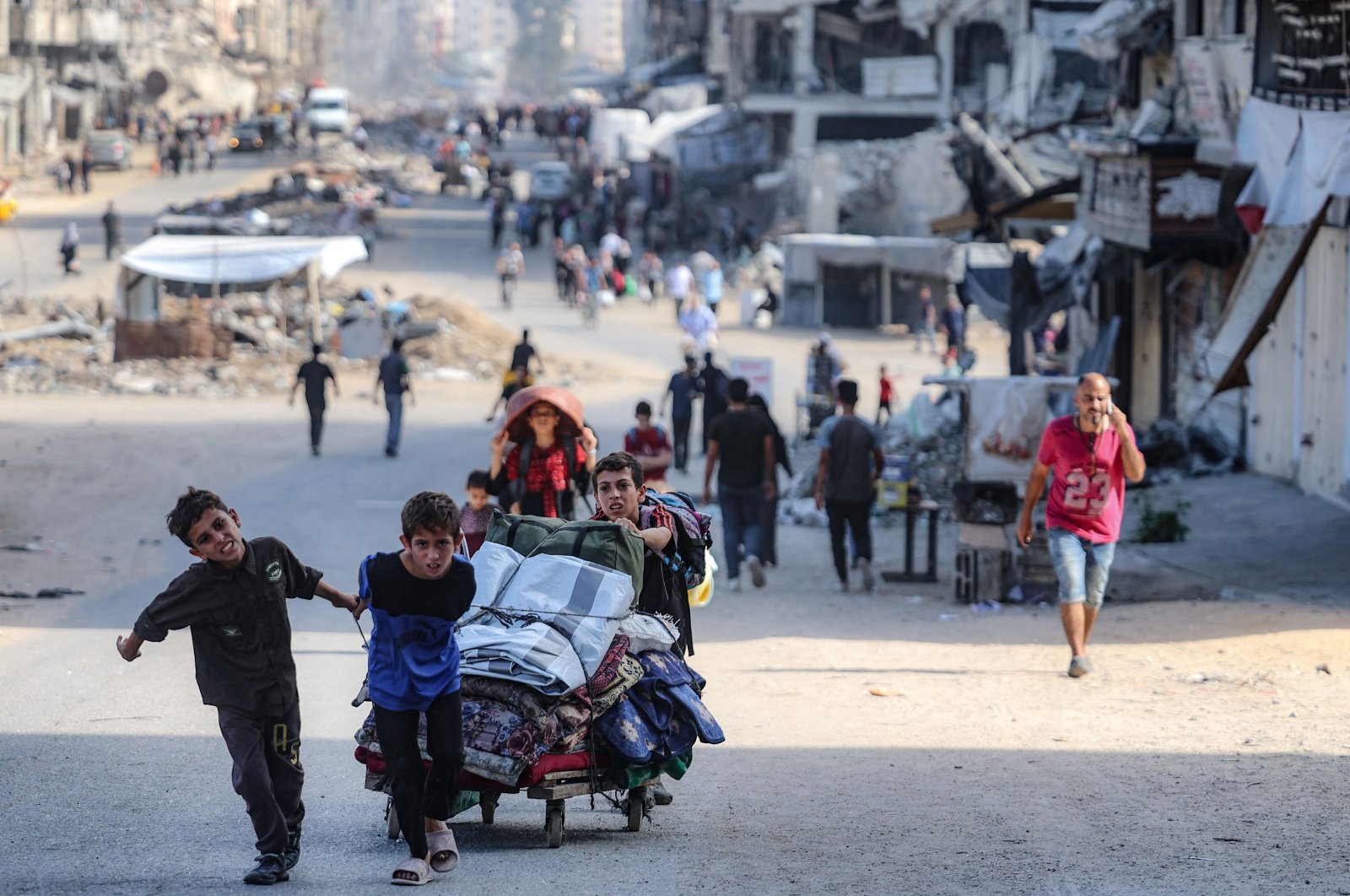 Palestinian children carry their belongings as they flee areas north of Gaza City in the northern Gaza Strip, Palestine, Oct. 12, 2024. (AFP Photo)