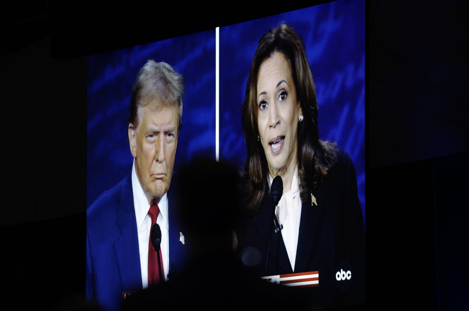 A tv screen shows the presidential debate between Donald Trump and Kamala Harris, in Philadelphia, U.S., Sept. 10, 2024. (AP Photo)