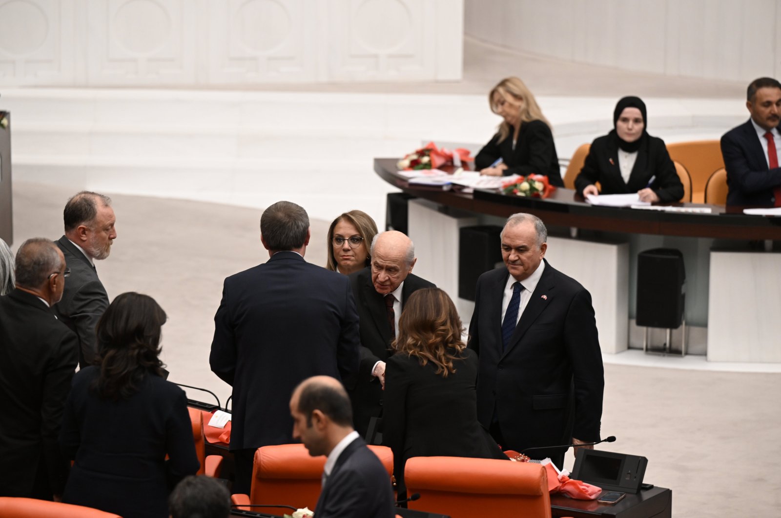 MHP leader Devlet Bahçeli (C) shakes hands with DEM Party lawmakers at Parliament, in the capital Ankara, Türkiye, Oct. 1, 2024. (AA Photo)