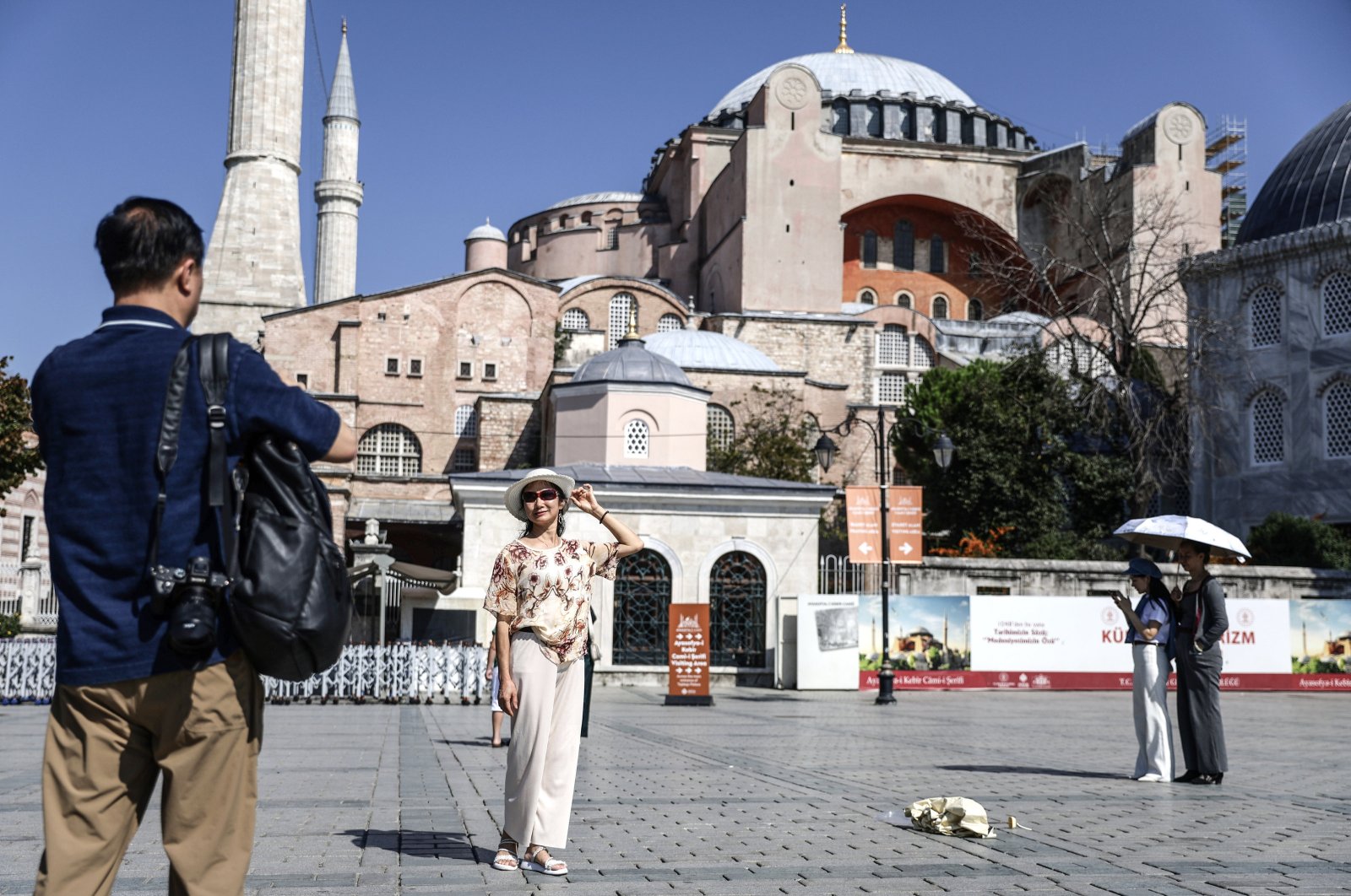 A tourist poses for pictures in front of the Hagia Sophia Grand Mosque on World Tourism Day, Istanbul, Türkiye, Sept. 27, 2024. (EPA Photo)