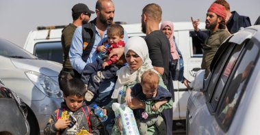 Syrians who were refugees in Lebanon return to their home country after a journey to the opposition-held northern Idlib province through the crossing of Aoun al-Dadat, north of Manbij, Syria, Oct. 9, 2024. (AFP Photo)
