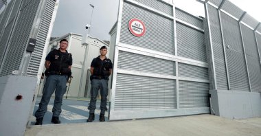 Italian police officers stand at the entrance of a recently built Italian-run migrant center at the port of Shengjin, Albania, Oct. 11, 2024. (AFP Photo)