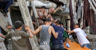 People rescue a man from the rubble of a collapsed building following Israeli bombardment, in Jabalia, northern Gaza Strip, Palestine, Oct. 15, 2024. (AFP Photo)