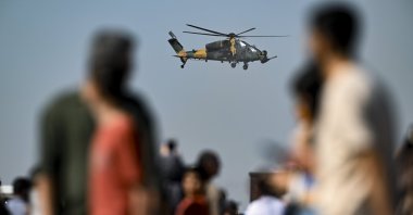 People watch as heavy-class attack helicopter ATAK performs an aerial demonstration during Türkiye&amp;amp;#039;s largest aerospace and technology festival, Teknofest, Adana, southern Türkiye, Oct. 2, 2024. (AA Photo)