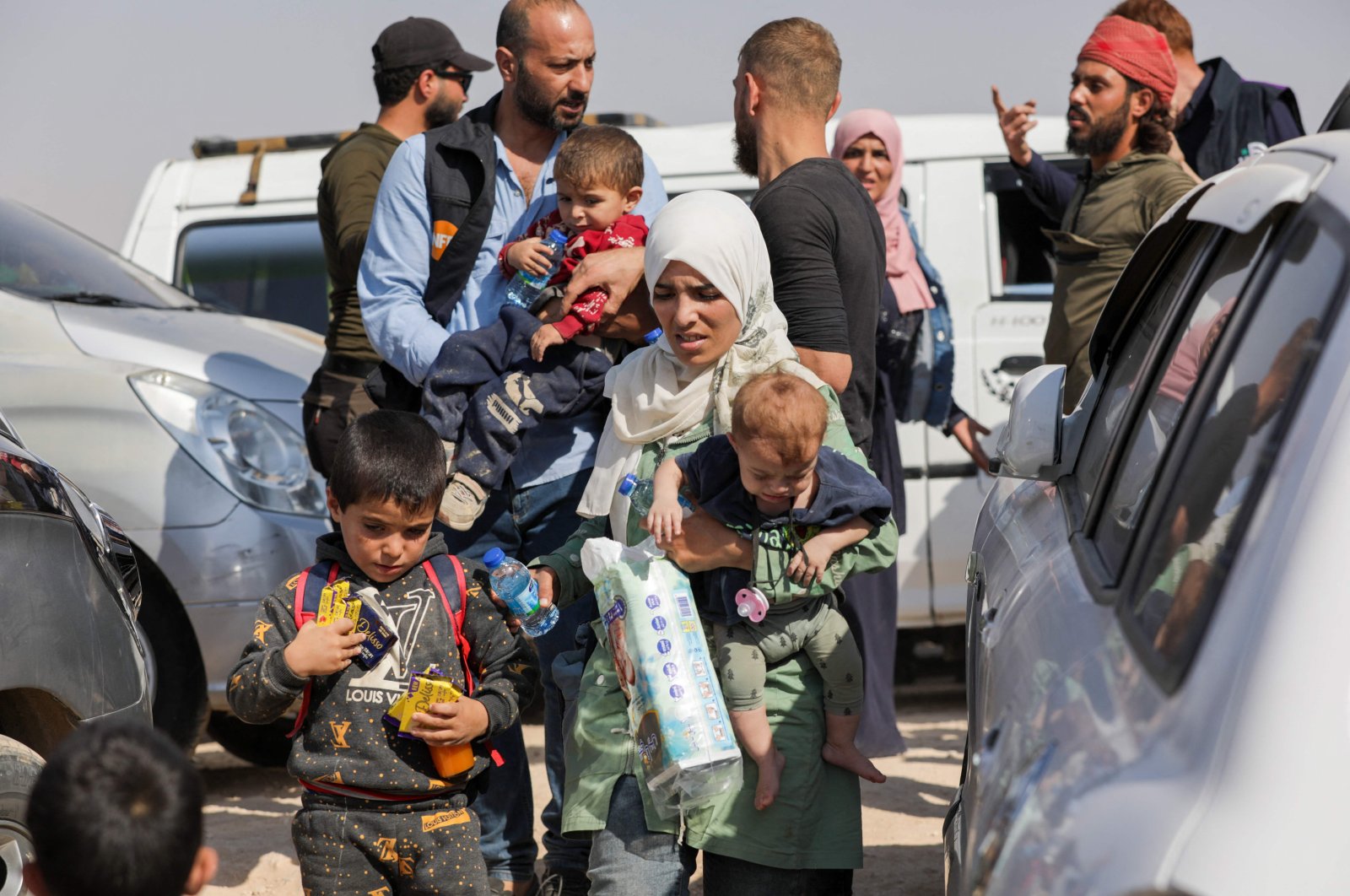 Syrians who were refugees in Lebanon return to their home country after a journey to the opposition-held northern Idlib province through the crossing of Aoun al-Dadat, north of Manbij, Syria, Oct. 9, 2024. (AFP Photo)