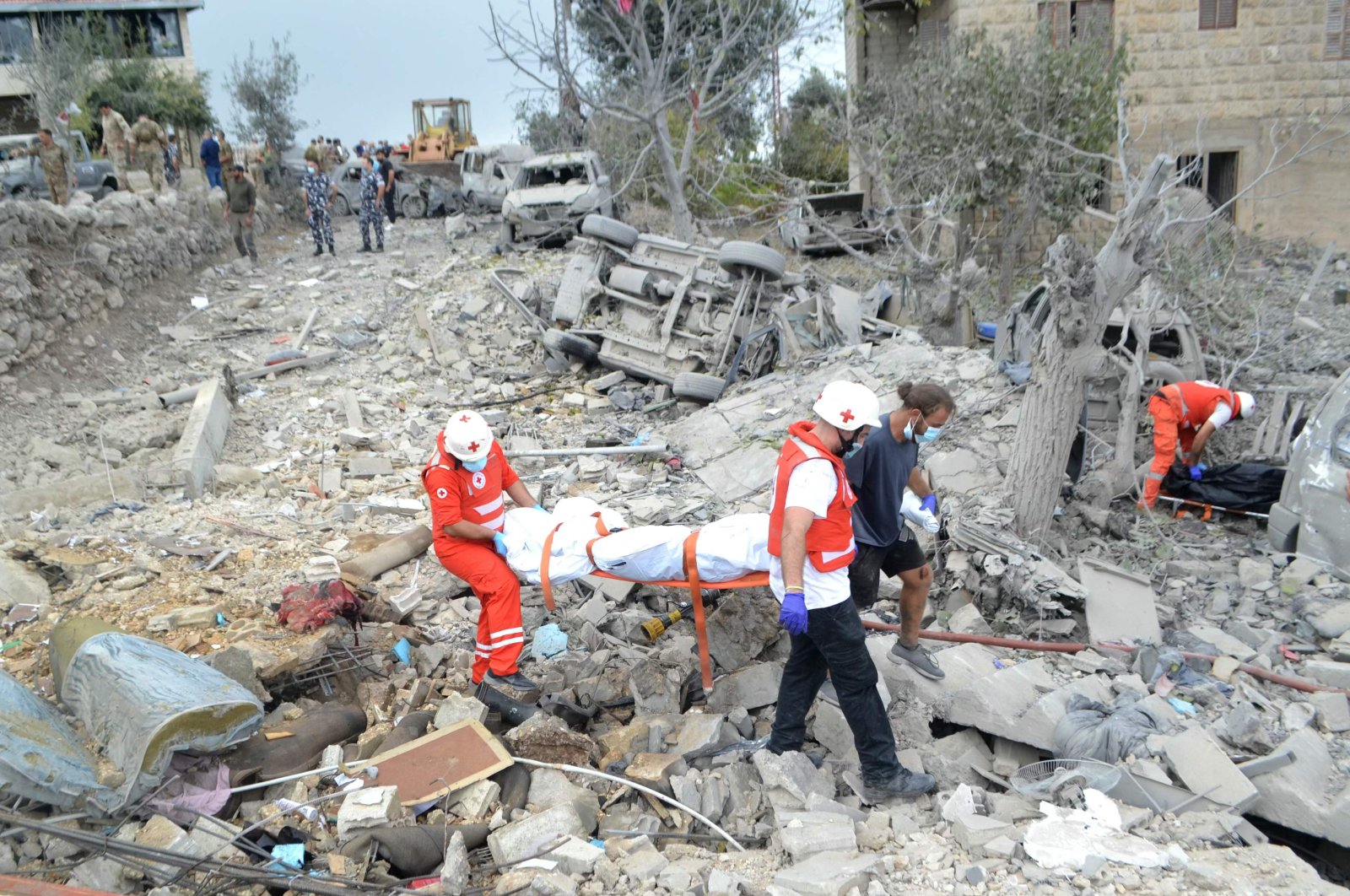 Paramedics with the Lebanese Red Cross carry a body unearthed from the rubble at the site of an Israeli airstrike that targeted the village of Aito, northern Lebanon, Oct. 14, 2024. (AFP Photo)