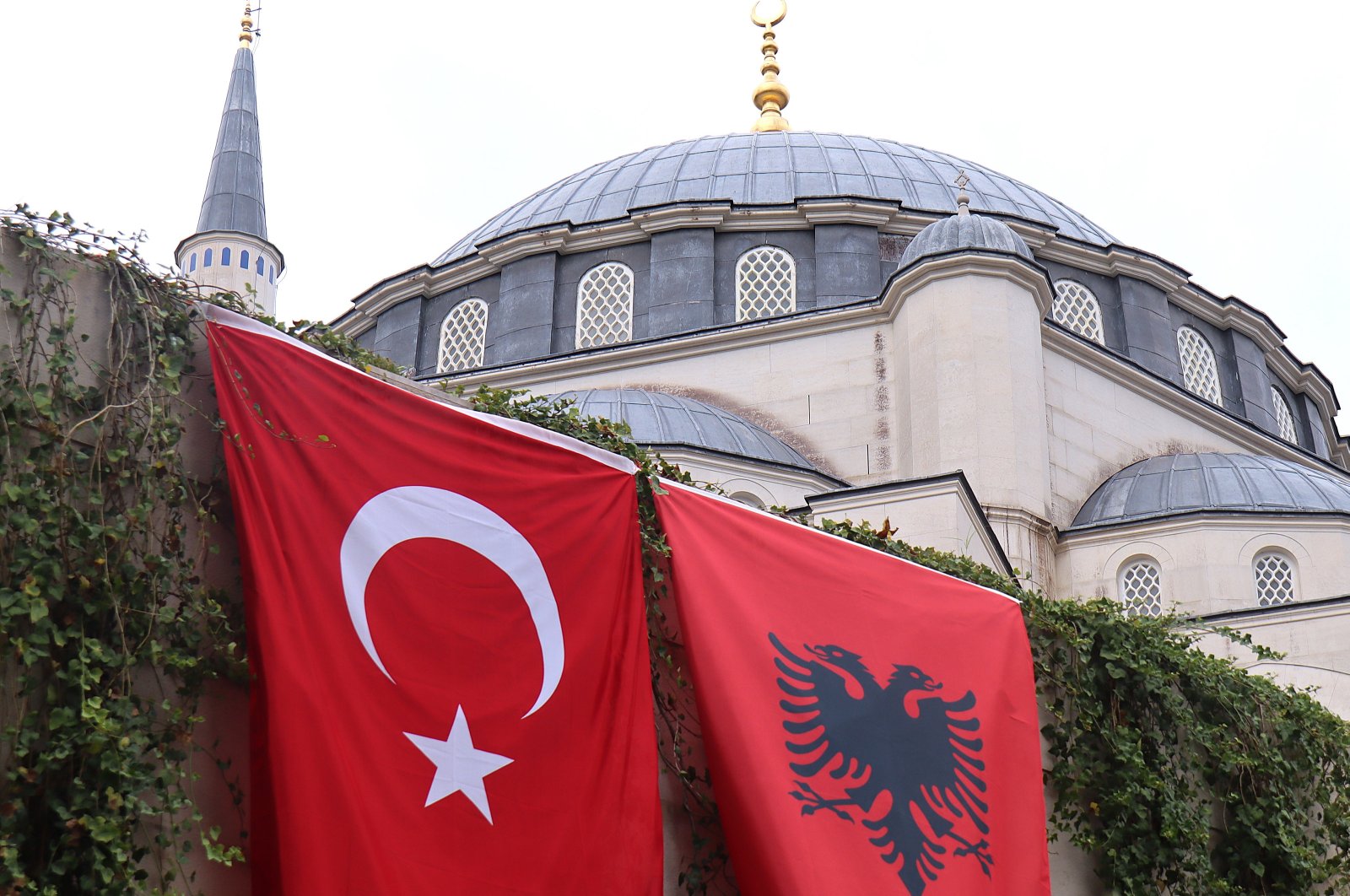 The flags of Türkiye and Albania hang on the wall of the Namazgah Mosque in Albania, built in 2015 with the support of Türkiye as the largest mosque in the Balkans, Tirana, Albania, Oct. 10, 2024. (AA Photo)