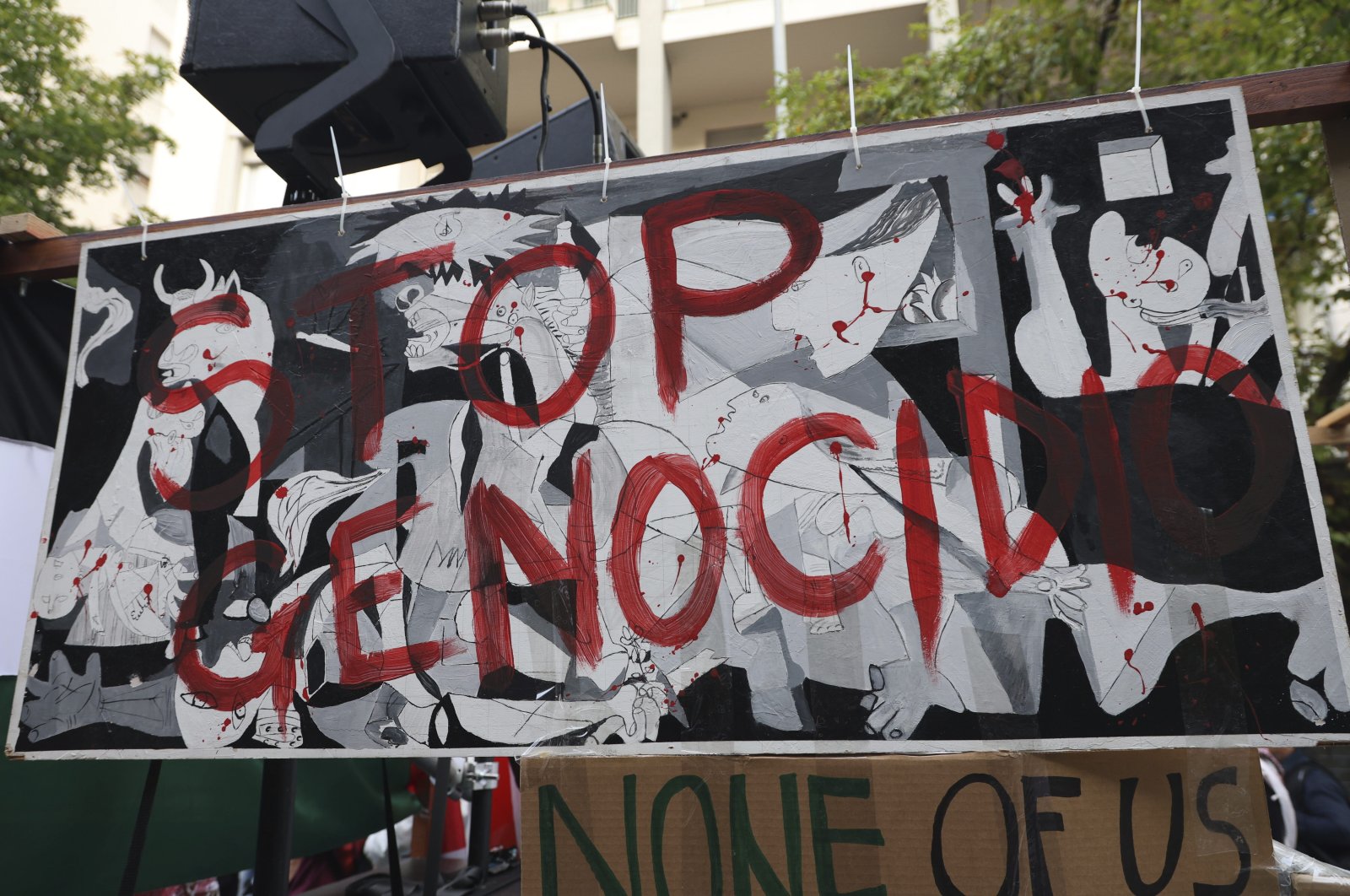 People taking part in a pro-Palestinians protest ahead of the Nations League match between Italy and Israel display a banner reading in Italian "Stop Genocide," Udine, Italy, Oct. 14, 2024. (AP Photo)