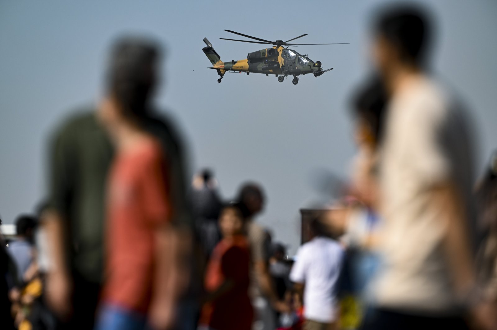 People watch as heavy-class attack helicopter ATAK performs an aerial demonstration during Türkiye&amp;amp;#039;s largest aerospace and technology festival, Teknofest, Adana, southern Türkiye, Oct. 2, 2024. (AA Photo)