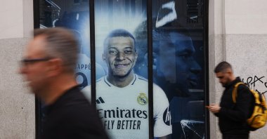 A general view of a poster of Real Madrid&#039;s Kylian Mbappe displayed outside the club shop as people walk past the Gran Via Street, Madrid, Spain, Oct. 15, 2024. (Reuters Photo)