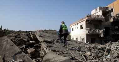 A civil defense member of the Islamic Health Authority walks on rubble at a site damaged by an Israeli strike, in Qana, southern Lebanon, Oct. 16, 2024. (Reuters Photo)
