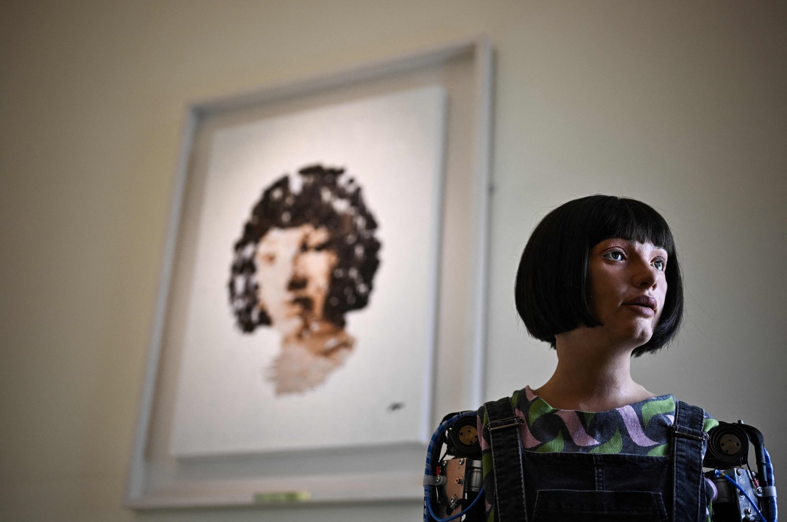 Ultra-realistic AI robot Ai-Da poses in front of a painting she made during the press preview of the London Design Biennale 2023 at Somerset House, central London, U.K., June 1, 2023. (AFP Photo)