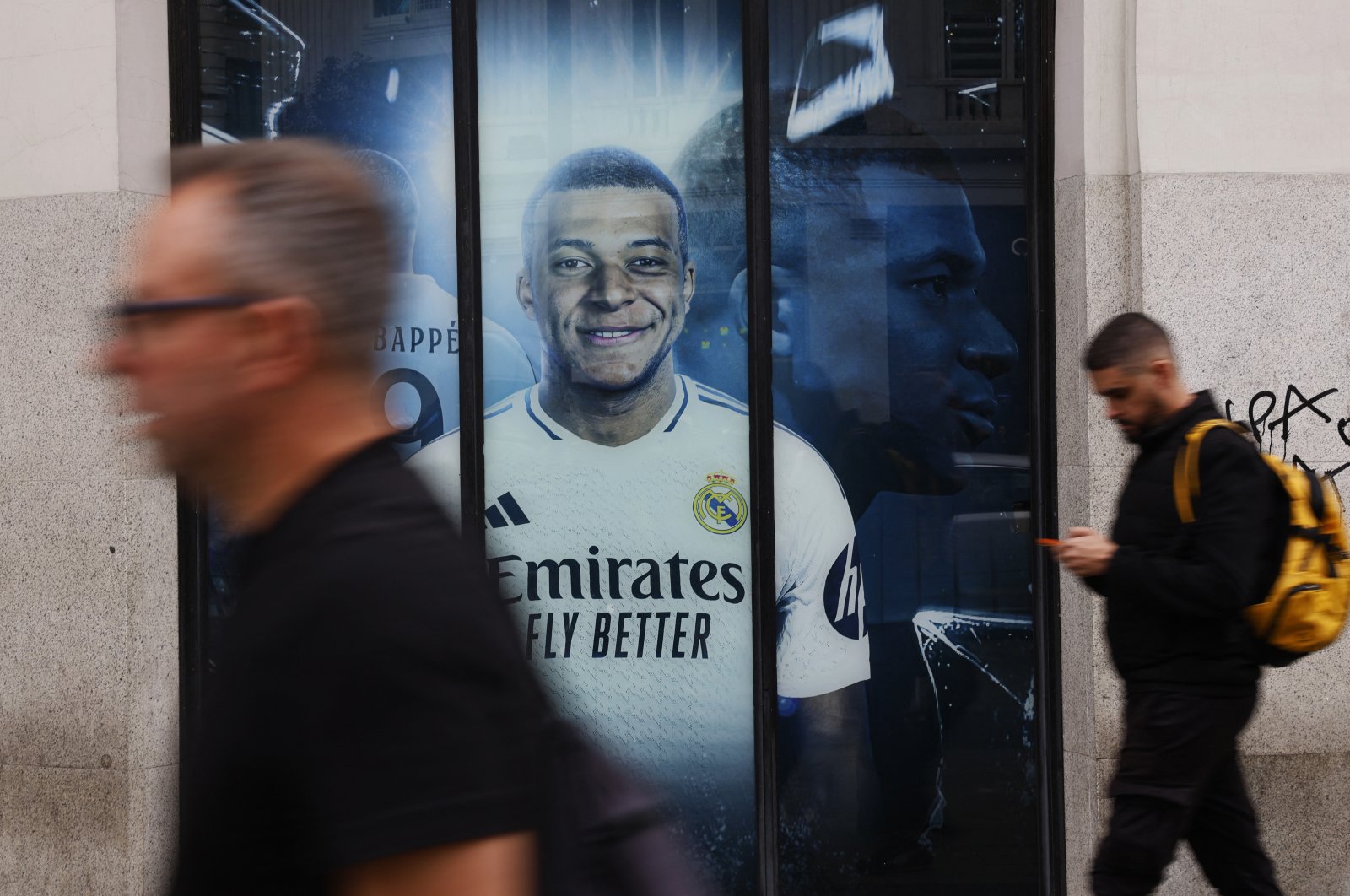 A general view of a poster of Real Madrid&#039;s Kylian Mbappe displayed outside the club shop as people walk past the Gran Via Street, Madrid, Spain, Oct. 15, 2024. (Reuters Photo)