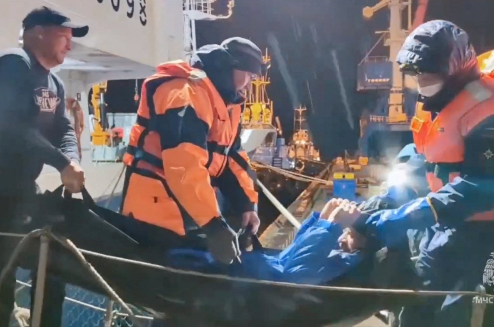 Rescuers leave a vessel while carrying a man, who was reportedly saved after his sailboat had drifted for 67 days in the Sea of ​​Okhotsk, Magadan, Russia, Oct. 15, 2024. (Reuters Photo)