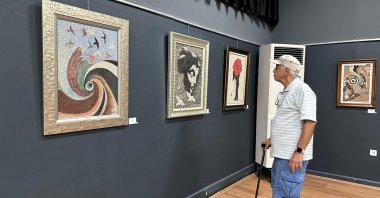 A visitor examines the artwork of artist Süleyman Sarı at Antalya Museum, Antalya, Türkiye, Oct. 16, 2024. (AA Photo)