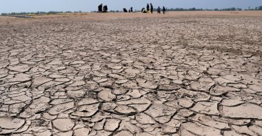 Greenpeace activists prepare a protest message over sandbanks exposed due to drought at the Solimoes River, one of the largest tributaries of the Amazon River, Brazil, Sept. 20, 2024. (Reuters Photo)
