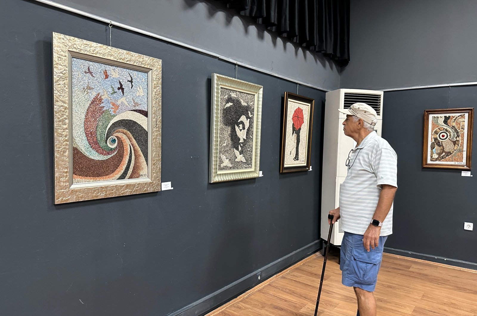 A visitor examines the artwork of artist Süleyman Sarı at Antalya Museum, Antalya, Türkiye, Oct. 16, 2024. (AA Photo)