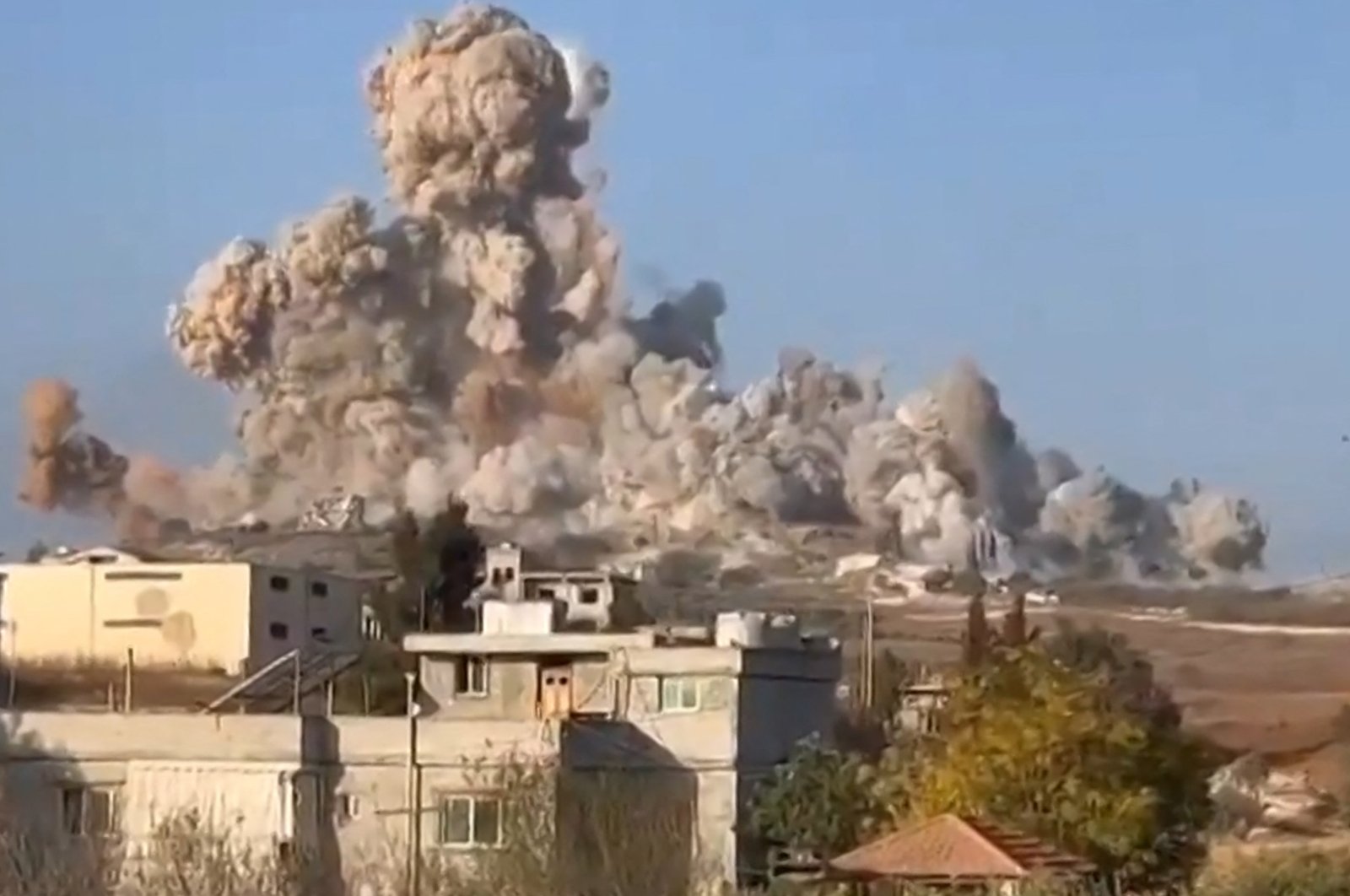 An image grab taken from a UGC video posted on social media shows soldiers observing massive explosions in the village of Mhaibib, southern Lebanon, Oct. 16, 2024. (AFP Photo)