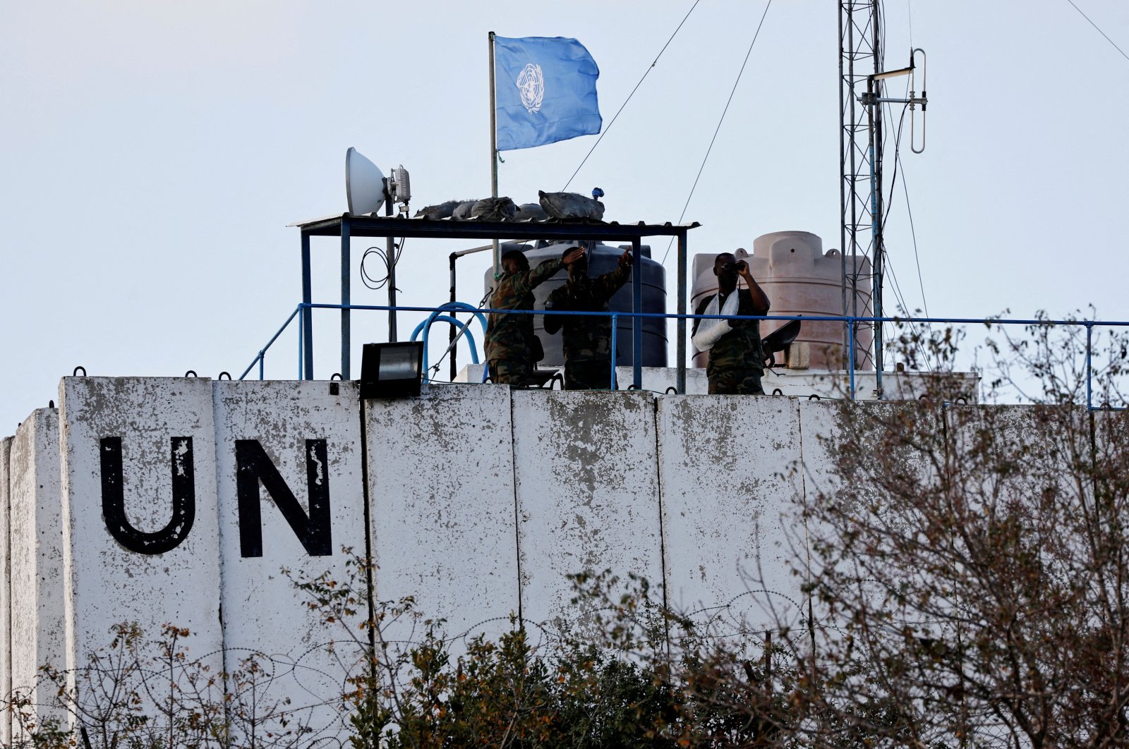 Members of the United Nations Interim Force in Lebanon (UNIFIL) look at the Lebanese-Israeli border, as they stand on the roof of a watch tower ‏in the town of Marwahin, southern Lebanon, Oct. 12, 2023. (Reuters Photo)