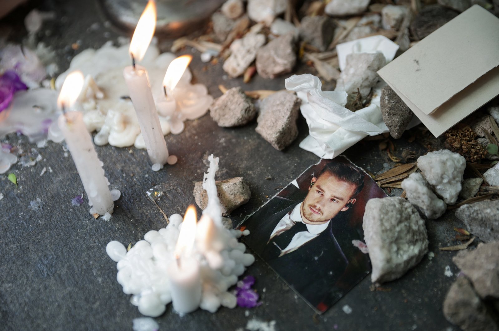 A picture of Liam Payne lays next to lit candles outside the hotel where former One Direction band member was found dead after he fell from a third-floor hotel room balcony, in Buenos Aires, Argentina, Oct. 17, 2024. (Reuters Photo)