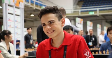 Turkish chess youngster Ediz Gürel smiles during a World Chess Olympiad match, Ankara, Türkiye, Sept. 23, 2024. (DHA Photo)