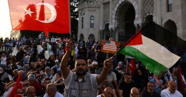 A demonstrator waves Turkish and Palestinian flags during a protest to express support for Palestinians in Gaza, a day ahead of the anniversary of the Oct. 7 attack, amid the Israel-Palestine conflict, Istanbul, Türkiye, Oct. 6, 2024. (Reuters Photo)