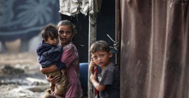 Palestinian children stand next to tents at a make-shift camp for the internally displaced in Deir al-Balah, Gaza Strip, Palestine, Oct. 17, 2024. (AFP Photo)