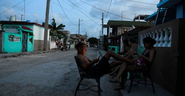 People sit outside their homes during a power outage caused by breakdowns forcing six plants to go off-line on the grid, according to the state-run power company, in Matanzas, Cuba Aug. 22, 2024. (Reuters File Photo)