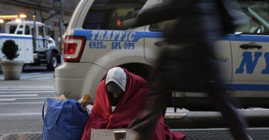 Mike Lago, a homeless man, sits on a sidewalk on Broadway near 37th Street, Monday, Jan. 4, 2016, in New York. (AP File Photo)