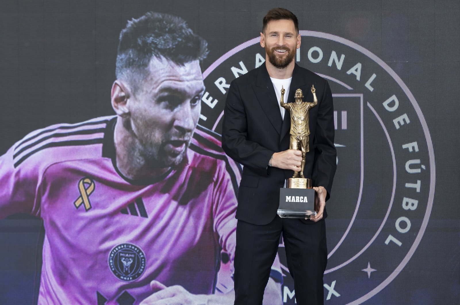 Inter Miami forward Lionel Messi holds the MARCA America Award during a ceremony at Chase Stadium, Fort Lauderdale, U.S., Oct. 17, 2024. (AP Photo)