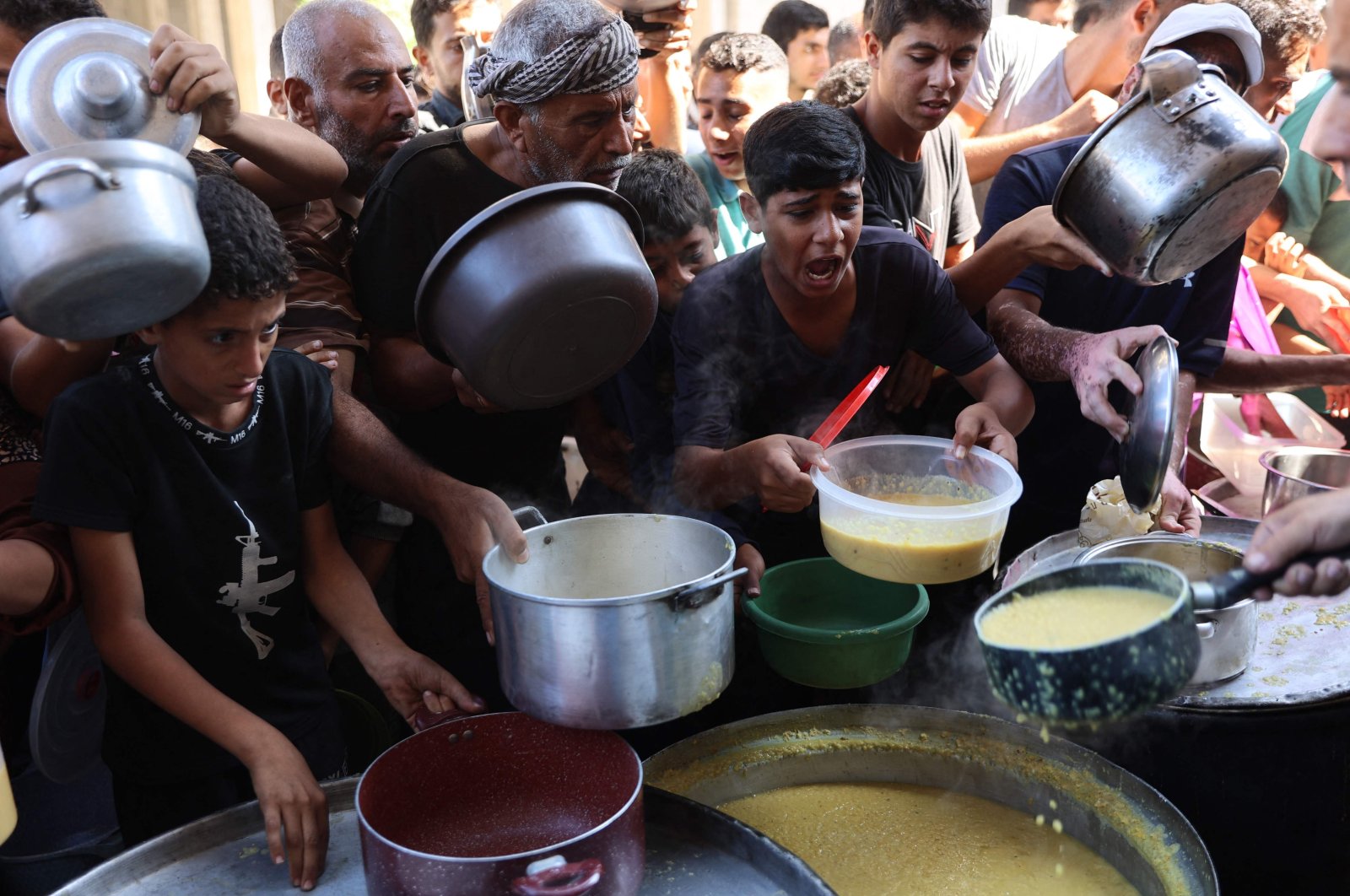 Displaced Palestinian people queue to receive food rations provided by a charity in Gaza&#039;s Al-Shati refugee camp, Gaza, Palestine, Oct. 17, 2024. (AFP Photo)