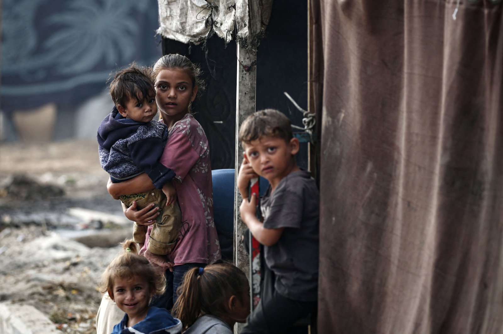 Palestinian children stand next to tents at a make-shift camp for the internally displaced in Deir al-Balah, Gaza Strip, Palestine, Oct. 17, 2024. (AFP Photo)