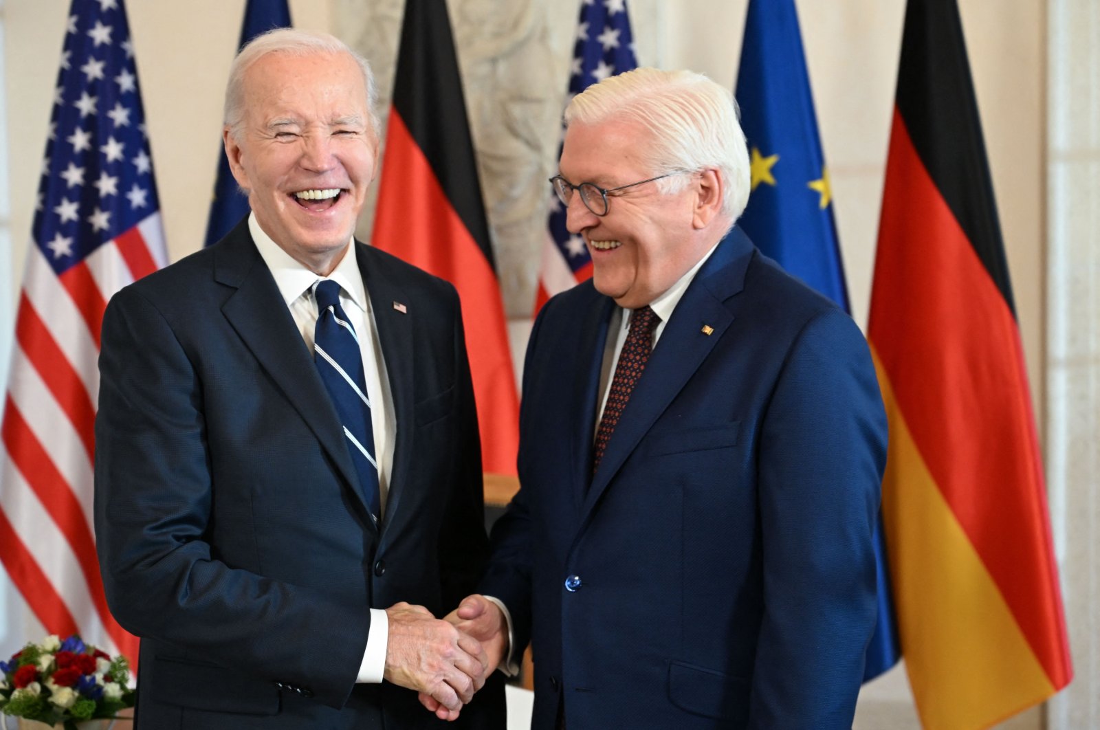 U.S. President Joe Biden (L) and German President Frank-Walter Steinmeier react as they shake hands at Bellevue presidential palace, Berlin, Germany, Oct. 18, 2024. (AFP Photo)