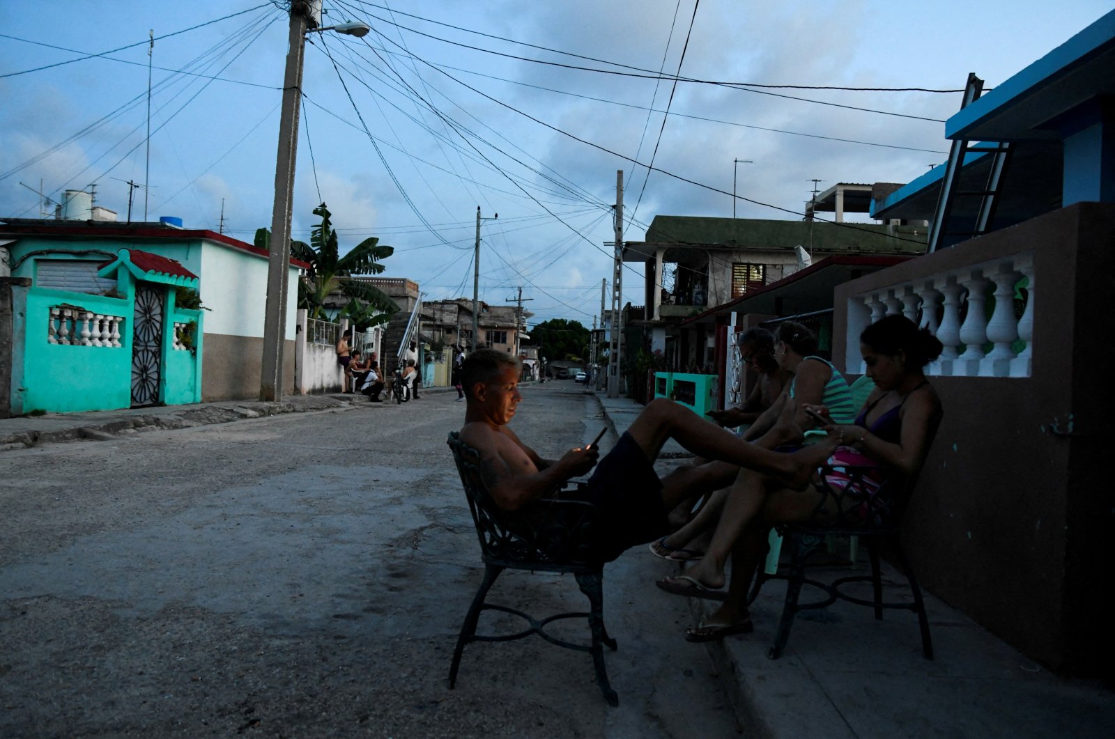 People sit outside their homes during a power outage caused by breakdowns forcing six plants to go off-line on the grid, according to the state-run power company, in Matanzas, Cuba Aug. 22, 2024. (Reuters File Photo)