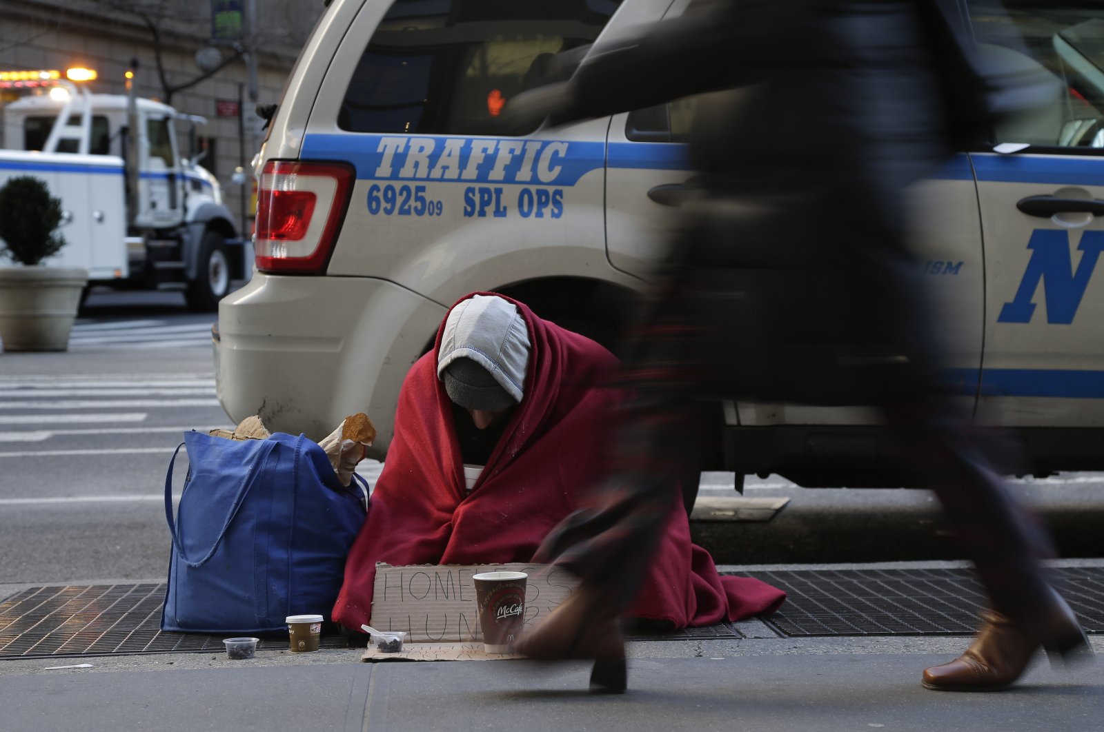 Mike Lago, a homeless man, sits on a sidewalk on Broadway near 37th Street, Monday, Jan. 4, 2016, in New York. (AP File Photo)