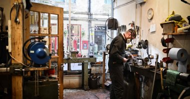 Artisan bagpipe maker Ruari Black, the last traditional bagpipe-makers who make everything by hand from start to finish, makes a bagpipe chanter in the workshop of Kilberry Bagpipes, Edinburgh, Scotland, Oct. 7, 2024. (AFP Photo)