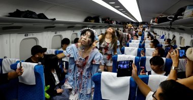 People dressed as zombies perform inside a &quot;Zombie Shinkansen&quot; bullet train bound for Osaka from Tokyo, inspired by the South Korean movie &quot;Train to Busan,&quot; ahead of the Halloween season, Tokyo, Japan, Oct. 19, 2024. (Reuters Photo)