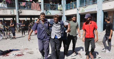 Displaced Palestinians help an injured man in the courtyard of a U.N. school-turned-refuge in the al-Shati refugee camp near Gaza City, northern Gaza Strip, Palestine, Oct. 19, 2024. (AFP Photo)
