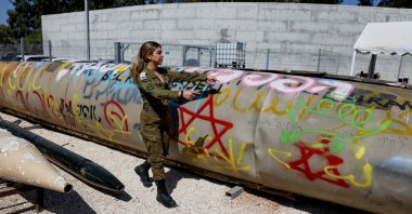 An Israeli soldier stands next to the remains of an Iranian Emad ballistic missile, at Julis army base, southern Israel, Oct. 9, 2024. (Reuters Photo)
