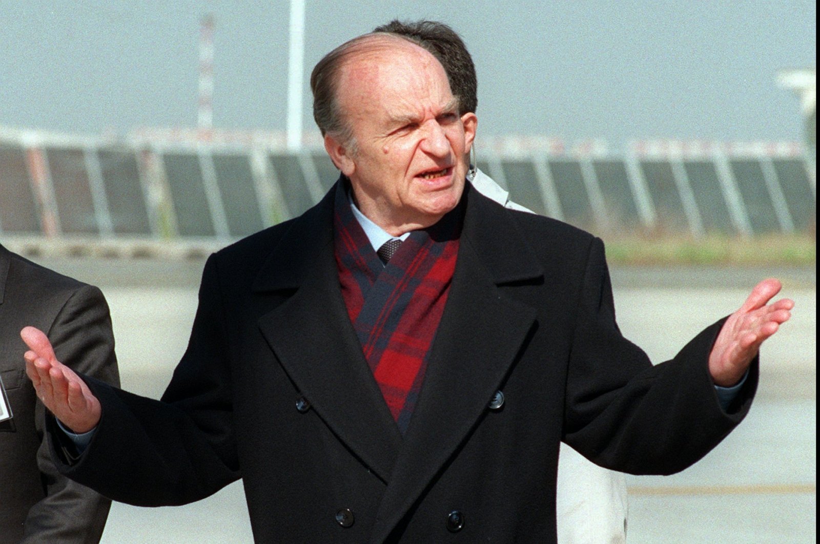 Bosnian President Aljia Izetbegovic gestures upon his arrival at Ciampino airport, Rome, Italy, Feb. 17, 1996. (AP Photo)