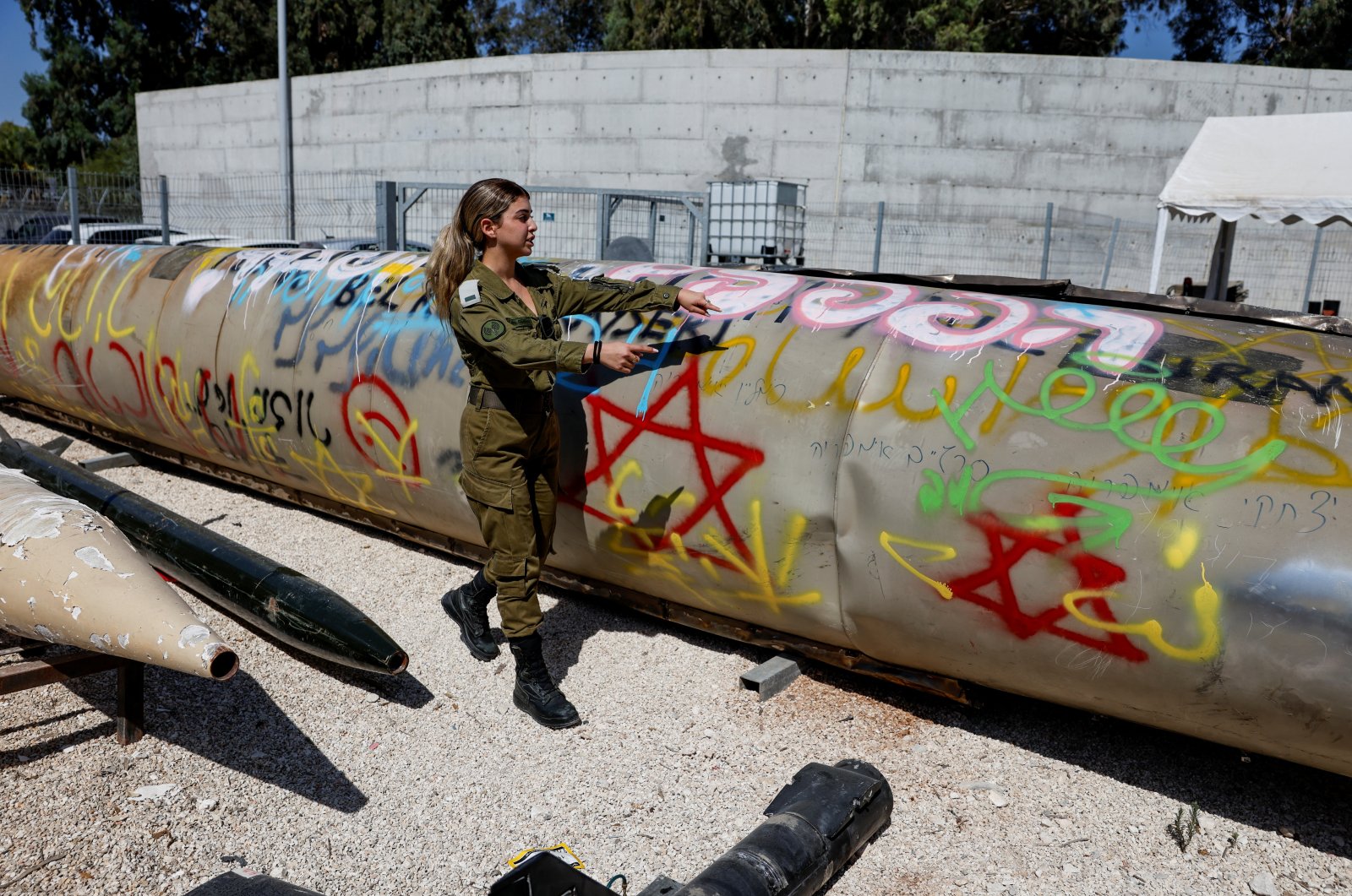 An Israeli soldier stands next to the remains of an Iranian Emad ballistic missile, at Julis army base, southern Israel, Oct. 9, 2024. (Reuters Photo)