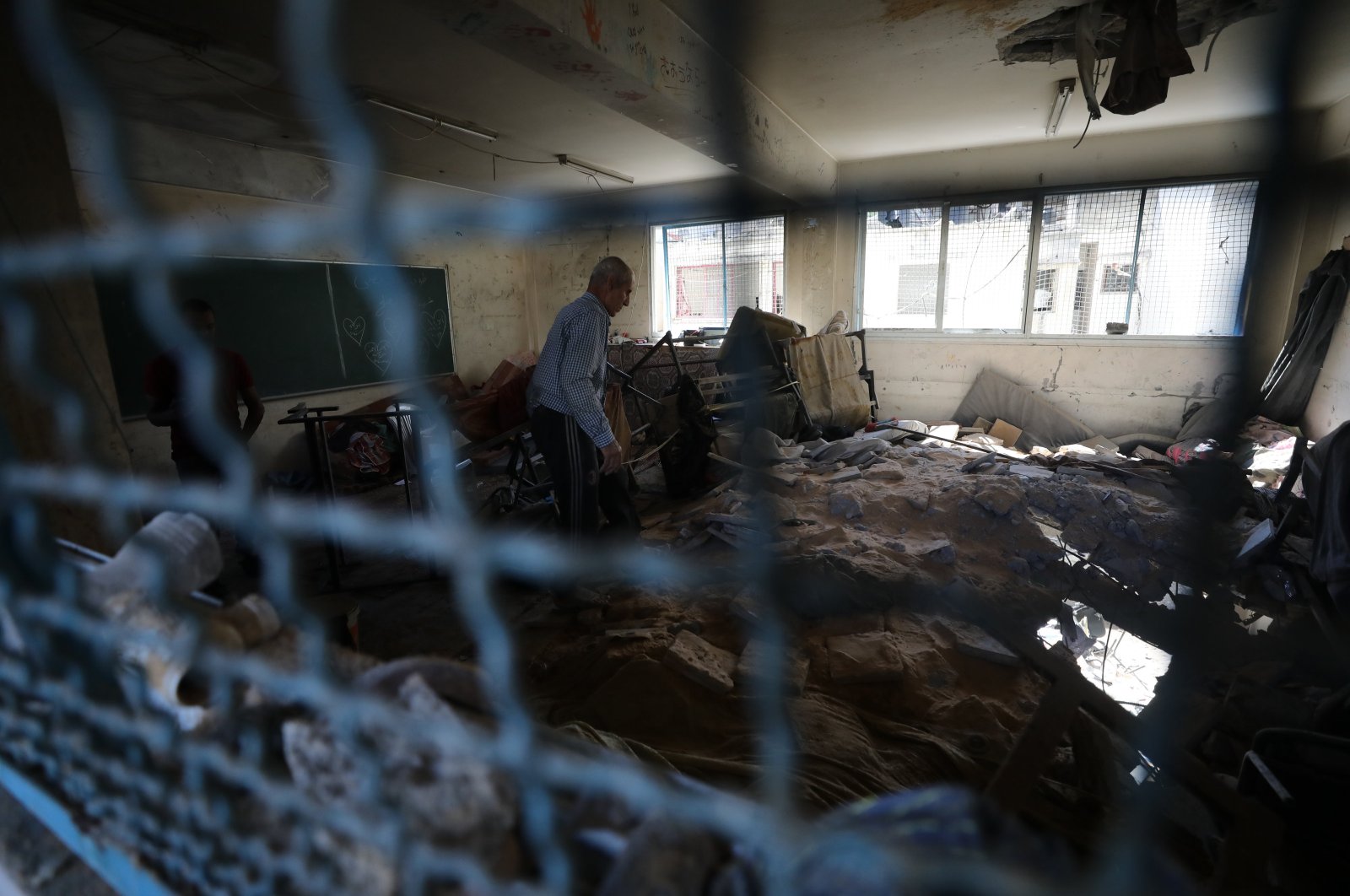 A displaced Palestinian is seen among the rubble of a U.N. school-turned-refuge in the Al-Shati refugee camp near Gaza City, northern Gaza Strip, Palestine, Oct. 19, 2024. (AA Photo)