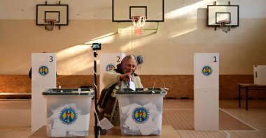A woman casts her ballots for the presidential election and referendum on joining the EU at a polling station, in Bulboaca village, Moldova, Oct. 20, 2024. (AFP Photo)
