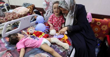 Palestinian girl Hanan al-Doqi, who lost both her legs in an Israeli strike, is cared for by her aunt Shiffa al-Doqi, as Hanan&#039;s sister Misk, also wounded in the strike, lies on a hospital bed, in Deir al-Balah, central Gaza Strip, Palestine, Sept. 16, 2024. (Reuters Photo)