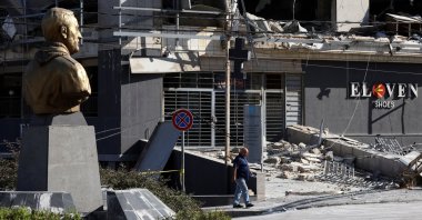 A man walks near a bust depicting late Iranian military commander Gen. Qassem Soleimani, past a site damaged in Israeli airstrikes, Beirut, Lebanon, Oct .21, 2024. (Reuters Photo)