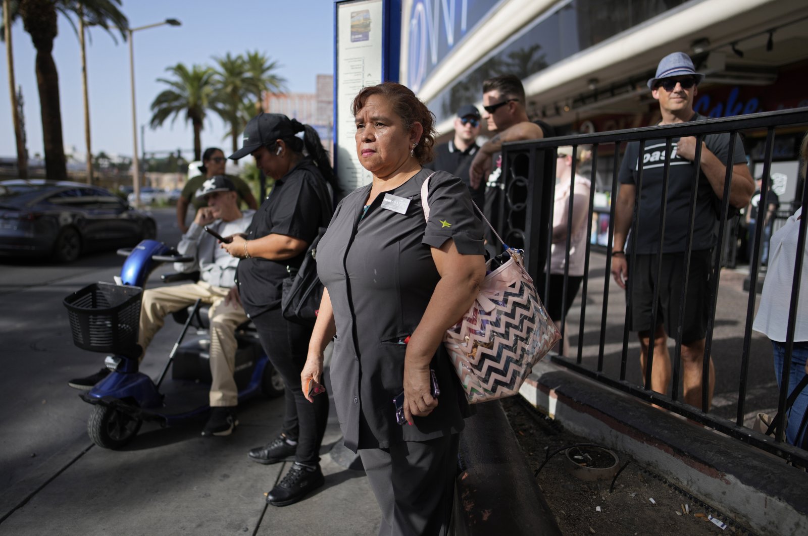 Haydee Zetino, an immigrant from El Salvador who gained temporary protected status since arriving in the wake of a major earthquake in 2001, waits for the bus after working a shift as a maid, Las Vegas, U.S., Sept. 12, 2024. (AP Photo)