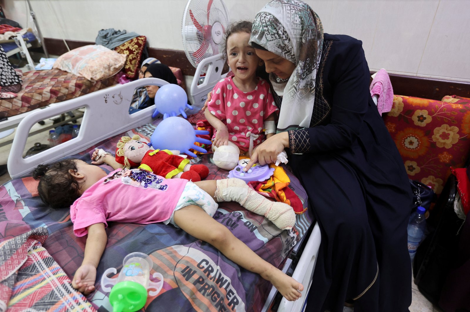 Palestinian girl Hanan al-Doqi, who lost both her legs in an Israeli strike, is cared for by her aunt Shiffa al-Doqi, as Hanan&#039;s sister Misk, also wounded in the strike, lies on a hospital bed, in Deir al-Balah, central Gaza Strip, Palestine, Sept. 16, 2024. (Reuters Photo)