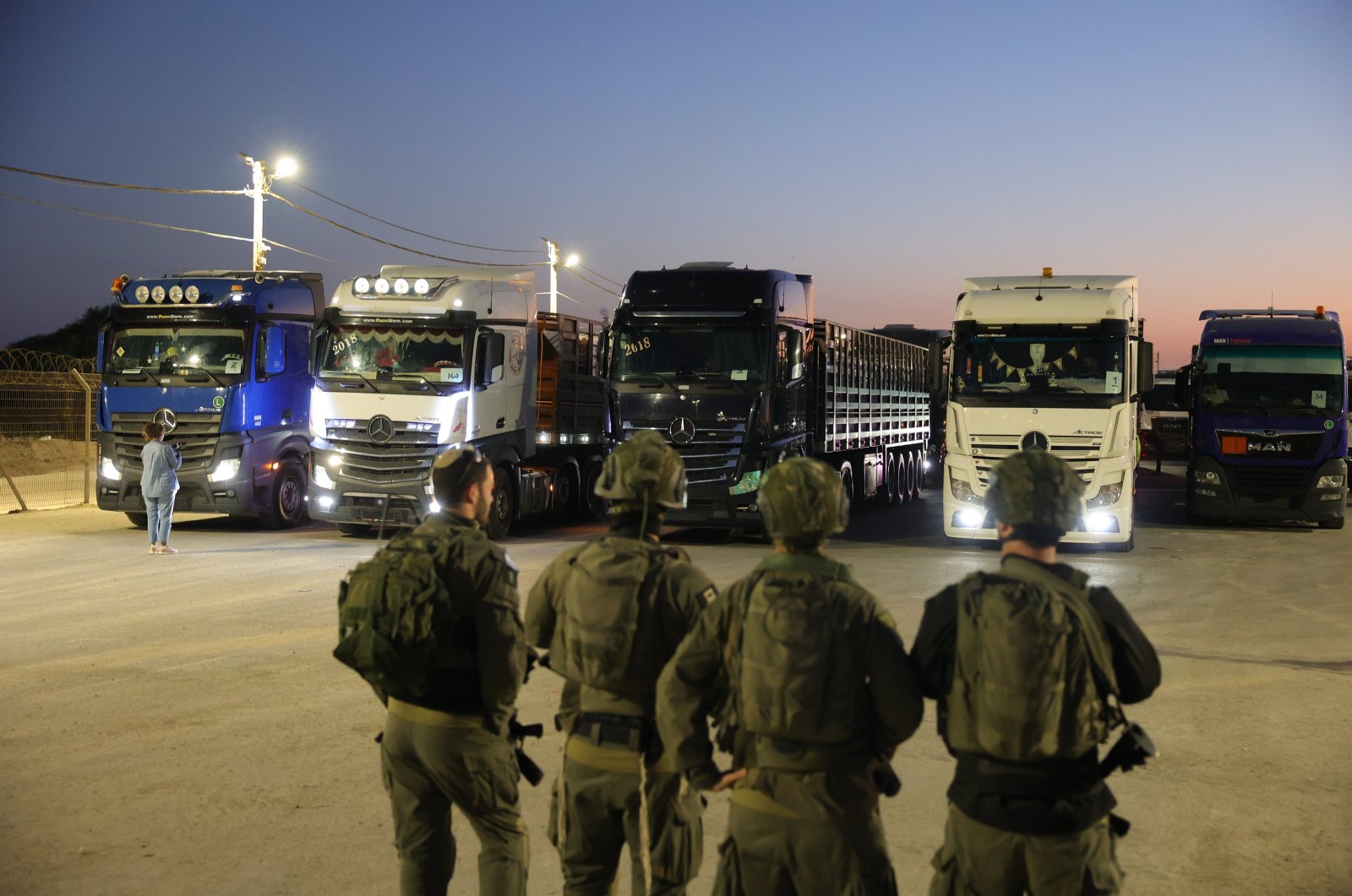 Israeli soldiers stand near Jordanian aid trucks at the Erez crossing on the border with northern Gaza Strip, Oct. 21, 2024. (EPA Photo)