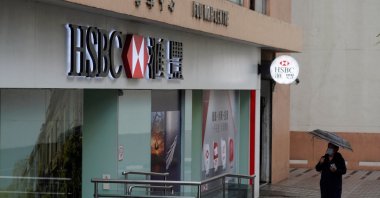 A pedestrian, wearing a face mask following the coronavirus outbreak, walks past an HSBC bank branch in Hong Kong, China, Feb. 22, 2022. (Reuters Photo)